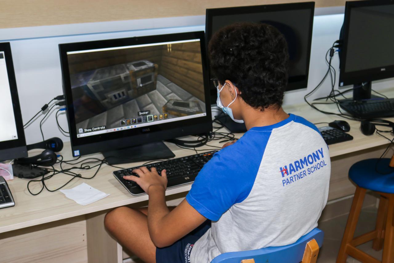 A person engaged in Minecraft game at IVY STEM International School's computer lab, showcasing the school's focus on technology and education.
